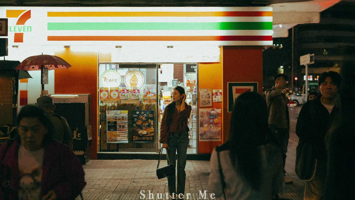 Couple posing under neon signs during a Hong Kong photoshoot with a professional photographer on Hong Kong Island